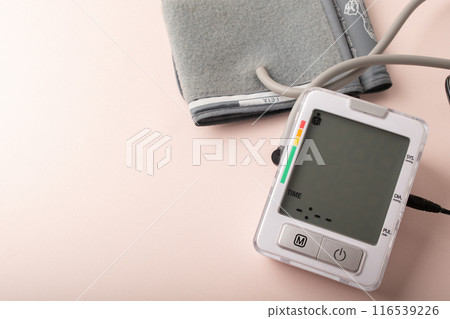 Tonometer close up. Measuring blood pressure on a pink background. Healthcare, disease treatment concept and health control. Hypertension and hypotension. Copy space. Banner. High quality photo Tonometer close up. Measuring blood pressure on a pink background. Healthcare, disease treatment concept and health control. Hypertension and hypotension. Copy space. Banner. High quality photo 116539226