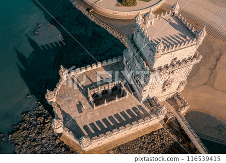 Top down drone shot of Belem tower, Lisbon, Portugal during low tide. Medieval fortification on Tagus river in late Gothic or Manueline style, UNESCO world heritage site, Age of Discoveries, tourist Top down drone shot of Belem tower, Lisbon, Portugal during low tide. Medieval fortification on Tagus river in late Gothic or Manueline style, UNESCO world heritage site, Age of Discoveries, tourist 116539415