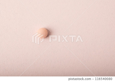 Pink pill close up isolated on pink background. Medicine dose. Concept of medicinal treatment, vitamins, supplements, contraceptive pills. Womens health. Copy space, banner. High quality photo Pink pill close up isolated on pink background. Medicine dose. Concept of medicinal treatment, vitamins, supplements, contraceptive pills. Womens health. Copy space, banner. High quality photo 116540080