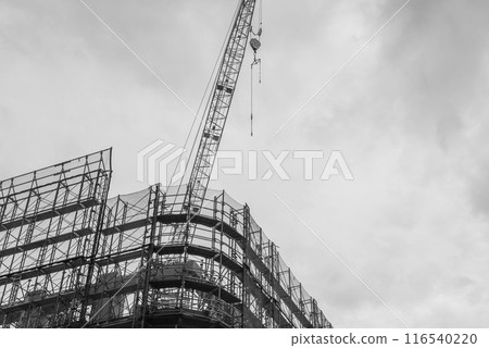 Construction site: scaffolding and cranes Construction site: scaffolding and cranes 116540220