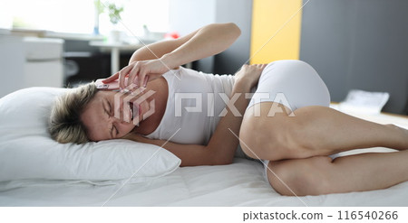 Upset blond woman screaming holding belly, calling to ambulance Upset blond woman screaming holding belly, calling to ambulance 116540266