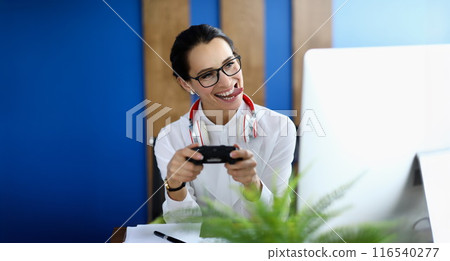 Joyful woman having fun with game console Joyful woman having fun with game console 116540277