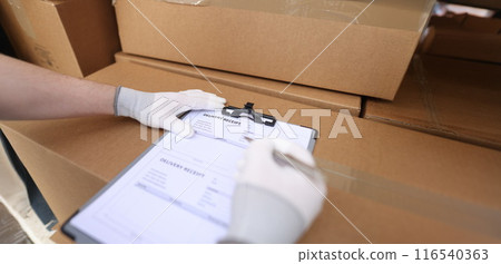 Courier service filling delivery receipt with client 116540363