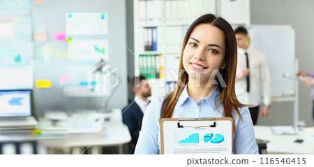 Smiling businesswoman stand with clipboard, manager analysing statistics date Smiling businesswoman stand with clipboard, manager analysing statistics date 116540415