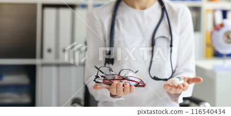 Female doctor making choice between contact lenses and glasses 116540434