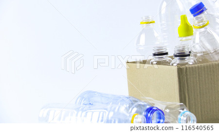 Clear plastic bottles on a white surface, awaiting recycling. Clear plastic bottles on a white surface, awaiting recycling. 116540565