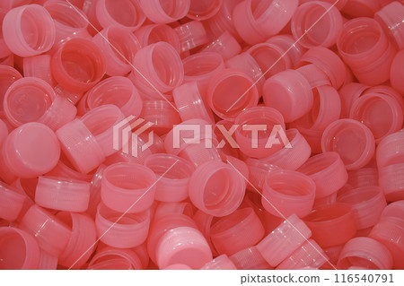The pile of red plastic caps of drinking water bottles. 116540791