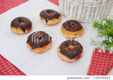 donuts with delicious chocolate coating as a background 116540941