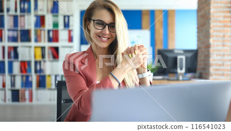 Smiling woman communicating via video call on laptop 116541023