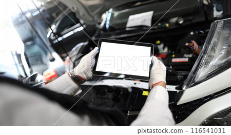 Mechanic worker using tablet for diagnostics of technical condition of vehicle 116541031