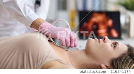Doctor endocrinologist doing ultrasound of thyroid gland in clinic Doctor endocrinologist doing ultrasound of thyroid gland in clinic 116541174