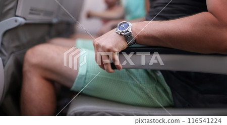 Scared man strongly grab armrest in plane Scared man strongly grab armrest in plane 116541224