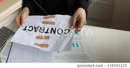 Torn sheet of paper with word contract glued with adhesive tape Torn sheet of paper with word contract glued with adhesive tape 116541225