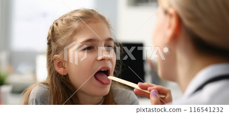 Pediatrician checking girls hurting throat with stick 116541232
