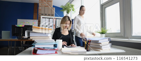 Young accountant working with papers in office 116541273