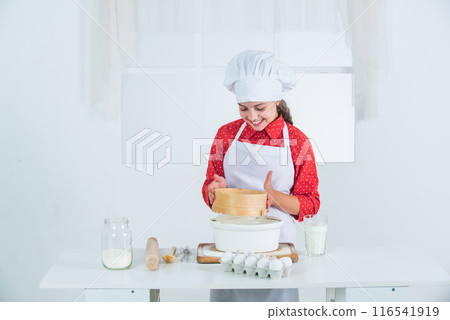 fine recipe. kid having fun with food at kitchen. Child and baking. Healthy eating and lifestyle. girl making dough from flour and eggs. dieting and health. culinary school. traditional cuisine fine recipe. kid having fun with food at kitchen. Child and baking. Healthy eating and lifestyle. girl making dough from flour and eggs. dieting and health. culinary school. traditional cuisine 116541919