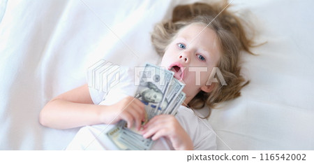 Small cheerful girl holding cash in hands 116542002