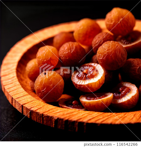 Dried longan slices pale brown with a smooth interior swirling gracefully in a mesmerizing spiral Dried longan slices pale brown with a smooth interior swirling gracefully in a mesmerizing spiral 116542266