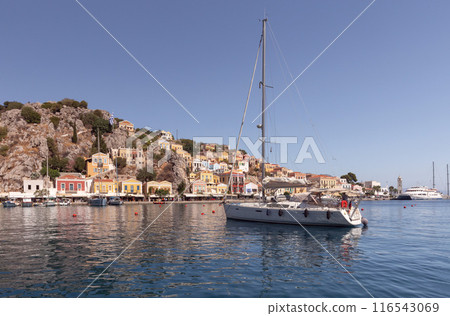 Bright multi-colored facades of houses on the shore of the bay in the village Symi Bright multi-colored facades of houses on the shore of the bay in the village Symi 116543069