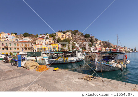 Bright multi-colored facades of houses on the shore of the bay in the village Symi Bright multi-colored facades of houses on the shore of the bay in the village Symi 116543073