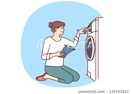 Woman turns on washing machine on knees with paper instruction with rules for using equipment 116543652