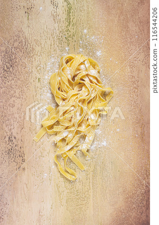 raw tagliatelli pasta , homemade, top view, no people, rustic, food concept, 116544206