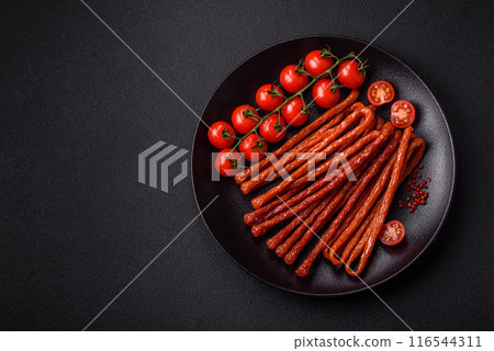 Mini sausages or cabanosi smoked with salt and spices 116544311