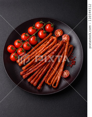 Mini sausages or cabanosi smoked with salt and spices Mini sausages or cabanosi smoked with salt and spices 116544312
