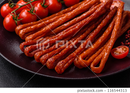 Mini sausages or cabanosi smoked with salt and spices 116544313