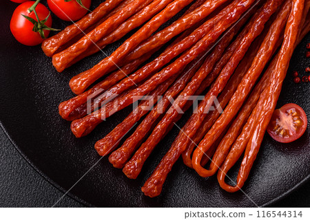 Mini sausages or cabanosi smoked with salt and spices 116544314
