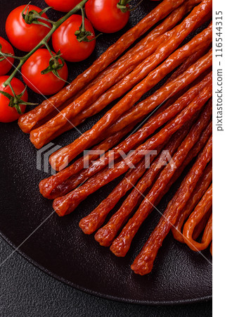 Mini sausages or cabanosi smoked with salt and spices 116544315