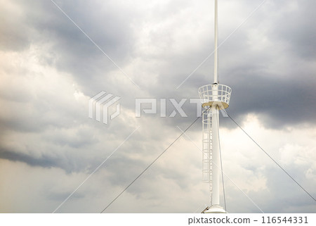 crow's nest  for spotting on the mast of a sailing yacht background with storm clouds. 116544331