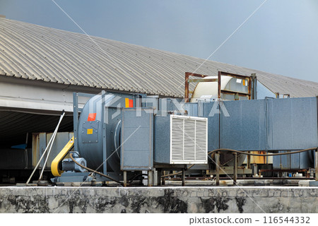External unit of air conditioning and ventilation system installed on industrial building roof. External unit of air conditioning and ventilation system installed on industrial building roof. 116544332