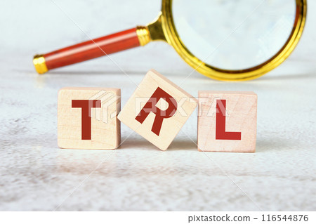 Concept of The wooden Cubes with the word TRL Technology Readiness Level assembled from wooden cubes with a magnifying glass in the background without focus Concept of The wooden Cubes with the word TRL Technology Readiness Level assembled from wooden cubes with a magnifying glass in the background without focus 116544876