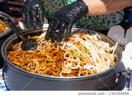 Udon Street Food, Chinese Fried Noodles in Wok, Asian Pasta Food in a Large Pot, Korean Spaghetti Udon Street Food, Chinese Fried Noodles in Wok, Asian Pasta Food in a Large Pot, Korean Spaghetti 116544894