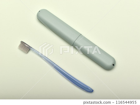 A toothbrush case and a toothbrush on a green background. A toothbrush case and a toothbrush on a green background. 116544955