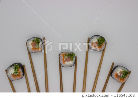 Artistic Sushi Presentation with Chopsticks on White Background Artistic Sushi Presentation with Chopsticks on White Background 116545108