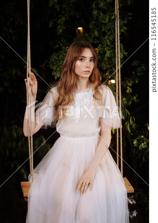Elegant woman on wooden swing. Elegant woman on wooden swing. 116545185