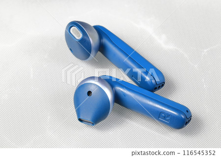 Blue bluetooth Wireless earphone or earbud or headphone, isolated on white background. Blue bluetooth Wireless earphone or earbud or headphone, isolated on white background. 116545352