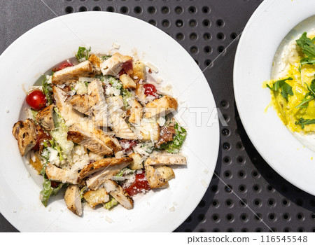 Caesar Salad, Green Lettuce Salat with Chicken and Parmesan Cheese Closeup 116545548
