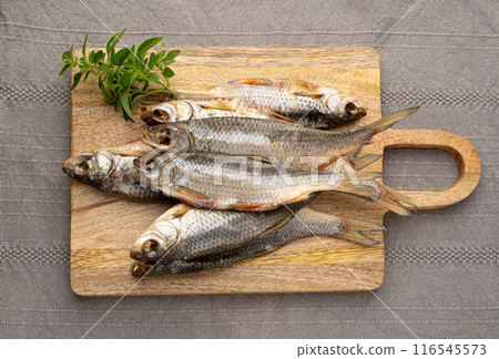 Dry roach, salted fish, dried rutilus, dehydrated vobla, taranka beer snack, whole salted arp on wood Dry roach, salted fish, dried rutilus, dehydrated vobla, taranka beer snack, whole salted arp on wood 116545573