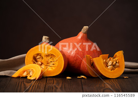 Hokkaido Pumpkins or Red Kuri Squash on a Wooden Table 116545589