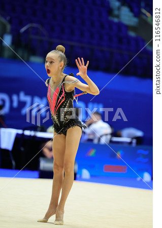 Rhythmic gymnast in black leotard displays agility, artistry, dedication at competition 116546812