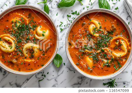 Creamy Tomato Vegetable and Tortellini Soup With Fresh Herbs on a White Marble Countertop Creamy Tomato Vegetable and Tortellini Soup With Fresh Herbs on a White Marble Countertop 116547099