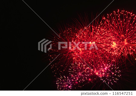 Rad fireworks with smoke over the black sky. 116547251