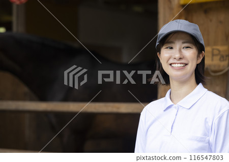 Woman taking care of a horse Woman taking care of a horse 116547803