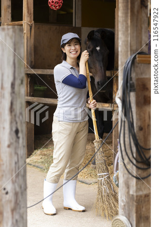 Woman taking care of a horse Woman taking care of a horse 116547922