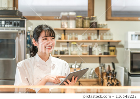 Restaurant staff checking orders on tablet Restaurant staff checking orders on tablet 116548222