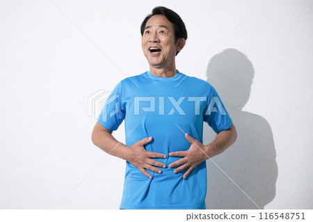 A middle-aged man touching his stomach with concern. An image of a middle-aged man's successful diet. A middle-aged man touching his stomach with concern. An image of a middle-aged man's successful diet. 116548751