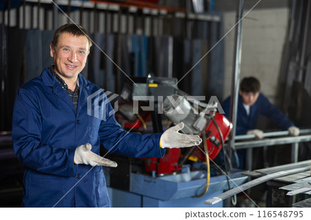 Portrait of male experienced engineer in a robe in workshop of metallurgical plant Portrait of male experienced engineer in a robe in workshop of metallurgical plant 116548795